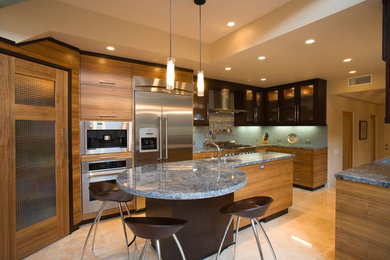 Example of a mid-sized trendy u-shaped ceramic tile and beige floor eat-in kitchen design in San Diego with flat-panel cabinets, medium tone wood cabinets, granite countertops, blue backsplash, mosaic tile backsplash, stainless steel appliances, an island and an undermount sink