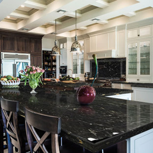 Design ideas for a large contemporary galley open plan kitchen in Baltimore with louvered cabinets, white cabinets, granite benchtops, black splashback, stone slab splashback, stainless steel appliances, marble floors, multiple islands and beige floor.