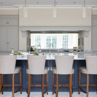 Large classic kitchen in Oxfordshire with shaker cabinets, grey cabinets, mirror splashback, stainless steel appliances, an island, beige floors and grey worktops.
