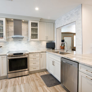 Small transitional kitchen inspiration - Inspiration for a small transitional porcelain tile and beige floor kitchen remodel in Miami with an undermount sink, recessed-panel cabinets, beige cabinets, granite countertops, gray backsplash, subway tile backsplash, stainless steel appliances and beige countertops