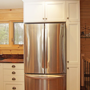 Mid-sized country l-shaped eat-in kitchen in Other with an undermount sink, shaker cabinets, white cabinets, granite benchtops, brown splashback, timber splashback, stainless steel appliances, medium hardwood floors, with island, brown floor and orange benchtop.
