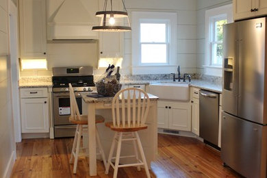 Kitchen - small coastal medium tone wood floor kitchen idea in Other with a farmhouse sink, shaker cabinets, granite countertops and stainless steel appliances