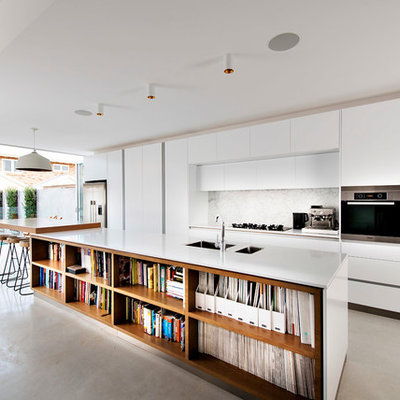 Inspiration for a contemporary galley kitchen remodel in Perth with white cabinets, stone slab backsplash, stainless steel appliances, an island, an undermount sink, flat-panel cabinets and quartz countertops