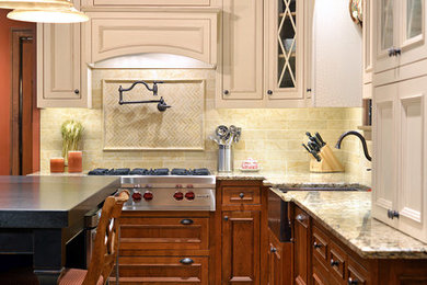 Inspiration for a mid-sized timeless l-shaped ceramic tile enclosed kitchen remodel in New York with a farmhouse sink, beaded inset cabinets, medium tone wood cabinets, granite countertops, beige backsplash, ceramic backsplash, paneled appliances and an island