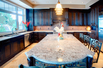 Example of a large classic u-shaped ceramic tile eat-in kitchen design in Toronto with a double-bowl sink, recessed-panel cabinets, dark wood cabinets, granite countertops, beige backsplash, mosaic tile backsplash, stainless steel appliances and an island