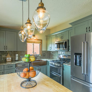 Small traditional l-shaped eat-in kitchen in Detroit with a farmhouse sink, shaker cabinets, green cabinets, quartz benchtops, grey splashback, glass tile splashback, stainless steel appliances, dark hardwood floors, with island, brown floor and beige benchtop.