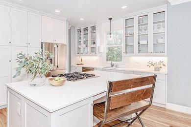 Kitchen - kitchen idea in Charlotte with flat-panel cabinets, gray cabinets, white backsplash and white countertops