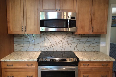 Example of a mid-sized trendy eat-in kitchen design in Denver with gray backsplash and ceramic backsplash
