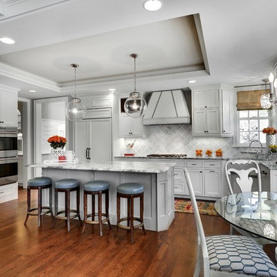 Inspiration for a transitional eat-in kitchen remodel in Minneapolis with recessed-panel cabinets, white cabinets, gray backsplash and white appliances