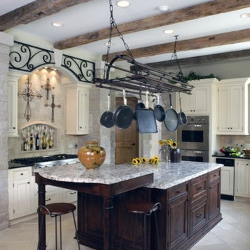 Country French Kitchen with Limestone Tile Floors and Rustic Beams