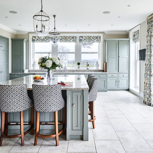 Classic kitchen in Cheshire with beaded cabinets, grey cabinets, grey splashback, black appliances, an island, beige floors and grey worktops.