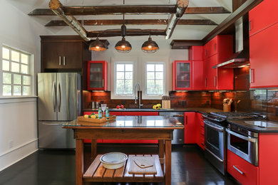 Kitchen - rustic l-shaped painted wood floor kitchen idea in Raleigh with flat-panel cabinets, red cabinets, brown backsplash, stainless steel appliances and an island