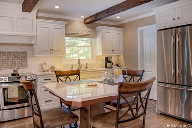 Inspiration for a mid-sized timeless medium tone wood floor enclosed kitchen remodel in Philadelphia with an undermount sink, beaded inset cabinets, white cabinets, quartzite countertops, green backsplash, ceramic backsplash, stainless steel appliances and an island