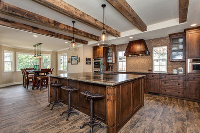 Inspiration for a large farmhouse l-shaped kitchen/diner in Sacramento with a submerged sink, shaker cabinets, medium wood cabinets, granite worktops, beige splashback, stainless steel appliances, medium hardwood flooring and an island.