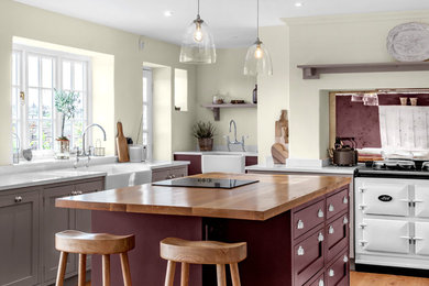 Inspiration for a classic kitchen in Other with a belfast sink, shaker cabinets, beige cabinets, white appliances, medium hardwood flooring, an island, brown floors and white worktops.