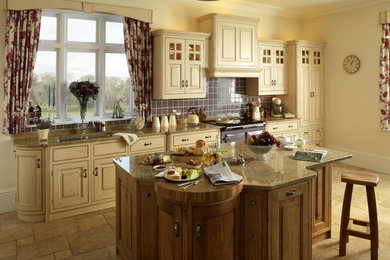 Inspiration for a traditional kitchen in London with raised-panel cabinets.