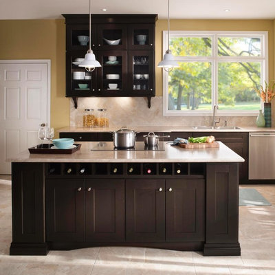 Example of a mid-sized eclectic l-shaped ceramic tile enclosed kitchen design in New York with a drop-in sink, flat-panel cabinets, medium tone wood cabinets, granite countertops, beige backsplash, ceramic backsplash, stainless steel appliances and an island