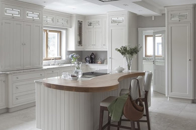 Design ideas for a victorian u-shaped kitchen in Dublin with a single-bowl sink, beaded cabinets, grey cabinets, quartz worktops, multi-coloured splashback, integrated appliances, porcelain flooring and an island.