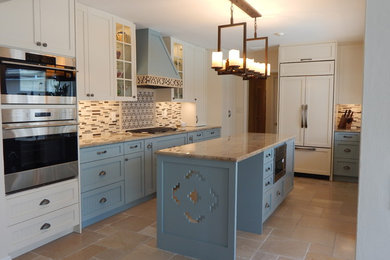 Example of a mid-sized country galley limestone floor and beige floor enclosed kitchen design in Miami with an undermount sink, shaker cabinets, blue cabinets, granite countertops, multicolored backsplash, matchstick tile backsplash, stainless steel appliances and an island