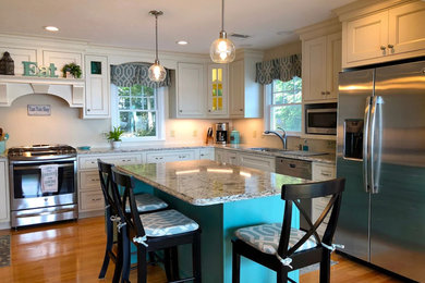 Example of a mid-sized farmhouse u-shaped medium tone wood floor and brown floor eat-in kitchen design in Boston with an undermount sink, beaded inset cabinets, white cabinets, granite countertops, white backsplash, stainless steel appliances, an island and multicolored countertops