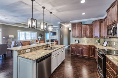 Inspiration for a mid-sized timeless dark wood floor and brown floor eat-in kitchen remodel in Other with a double-bowl sink, granite countertops, multicolored backsplash, stainless steel appliances and an island