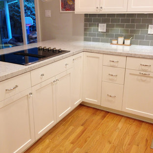 Transitional eat-in kitchen inspiration - Inspiration for a transitional l-shaped eat-in kitchen remodel in San Francisco with an undermount sink, shaker cabinets, white cabinets, quartz countertops, green backsplash, porcelain backsplash and stainless steel appliances