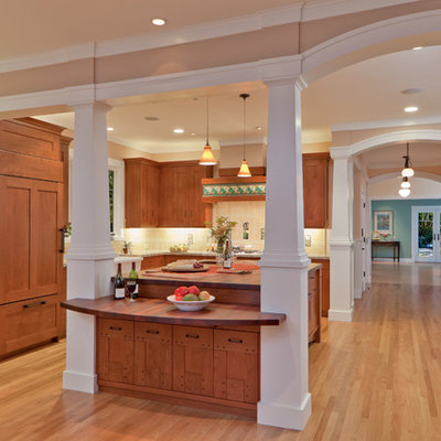 Eat-in kitchen - huge craftsman l-shaped light wood floor eat-in kitchen idea in San Francisco with a farmhouse sink, shaker cabinets, medium tone wood cabinets, granite countertops, yellow backsplash, ceramic backsplash, paneled appliances and an island