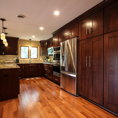 Eat-in kitchen - craftsman u-shaped eat-in kitchen idea in Detroit with an undermount sink, shaker cabinets, medium tone wood cabinets, quartz countertops, beige backsplash, stone tile backsplash and stainless steel appliances