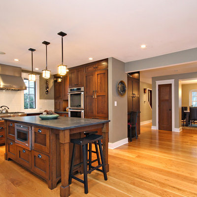 Example of a minimalist medium tone wood floor kitchen design in Chicago