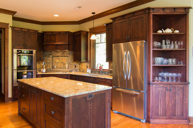 Kitchen - craftsman light wood floor kitchen idea in Other with an undermount sink, medium tone wood cabinets, granite countertops, stone tile backsplash, stainless steel appliances, an island and raised-panel cabinets