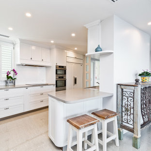Design ideas for a mid-sized transitional kitchen in Perth with a double-bowl sink, white cabinets, white splashback, ceramic splashback, stainless steel appliances, marble floors, brown floor and shaker cabinets.