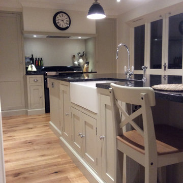 Cream, modern handmade kitchen with large island and black worktops