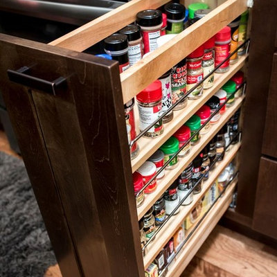 Large arts and crafts l-shaped medium tone wood floor and brown floor eat-in kitchen photo in Other with an undermount sink, shaker cabinets, brown cabinets, granite countertops, brown backsplash, brick backsplash, stainless steel appliances, two islands and multicolored countertops