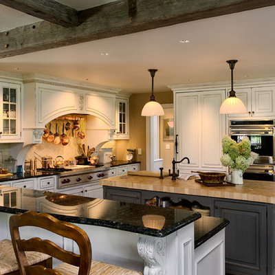 Elegant l-shaped eat-in kitchen photo in New York with white cabinets, granite countertops, paneled appliances, an undermount sink, beaded inset cabinets, white backsplash and subway tile backsplash