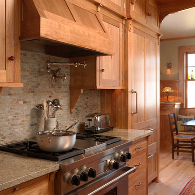Inspiration for a craftsman medium tone wood floor eat-in kitchen remodel in Minneapolis with recessed-panel cabinets, light wood cabinets, gray backsplash, stainless steel appliances, no island, granite countertops, a farmhouse sink and slate backsplash