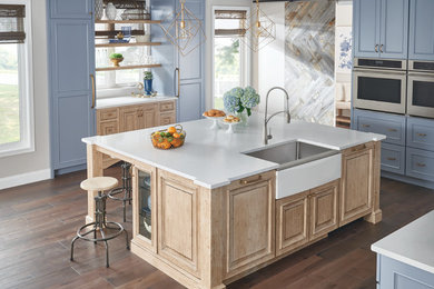 Inspiration for a kitchen remodel in Chicago with a farmhouse sink, stainless steel appliances, white countertops and blue cabinets