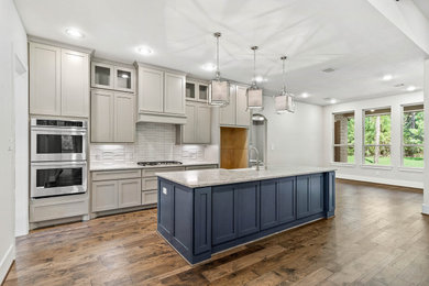 Eat-in kitchen - transitional eat-in kitchen idea in Houston with shaker cabinets, gray cabinets, quartz countertops, white backsplash, an island and gray countertops