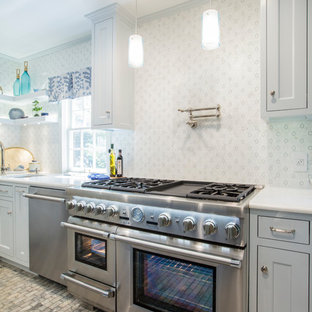 Inspiration for a mid-sized transitional single-wall eat-in kitchen in Oklahoma City with a double-bowl sink, recessed-panel cabinets, grey cabinets, recycled glass benchtops, multi-coloured splashback, mosaic tile splashback, stainless steel appliances, marble floors, with island, multi-coloured floor and white benchtop.