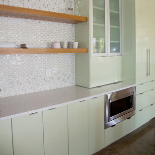This is an example of a medium sized contemporary open plan kitchen in Miami with flat-panel cabinets, green cabinets, multi-coloured splashback, mosaic tiled splashback, stainless steel appliances, an island and quartz worktops.