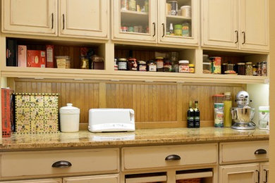 Example of a small classic single-wall kitchen pantry design in Other with flat-panel cabinets, distressed cabinets and granite countertops