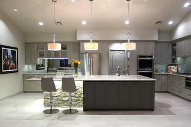 Example of a huge trendy single-wall porcelain tile open concept kitchen design in Phoenix with a single-bowl sink, shaker cabinets, gray cabinets, granite countertops, gray backsplash, glass tile backsplash, stainless steel appliances and an island