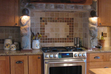 Inspiration for a mid-sized rustic medium tone wood floor kitchen remodel with shaker cabinets, medium tone wood cabinets, granite countertops, beige backsplash, stone tile backsplash, stainless steel appliances and an island