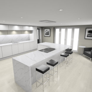 Photo of a large modern eat-in kitchen in Cardiff with an integrated sink, flat-panel cabinets, white cabinets, quartz benchtops, black appliances, porcelain floors, with island, yellow floor and white benchtop.