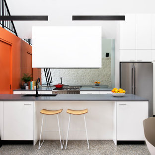 Inspiration for a contemporary galley kitchen in Melbourne with an undermount sink, stainless steel appliances, a peninsula, grey floor, grey benchtop and vaulted.