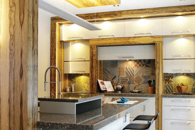 Inspiration for a contemporary kitchen remodel in Montreal with flat-panel cabinets and an island