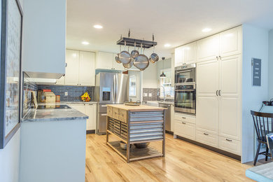 Mid-sized farmhouse kitchen photo in DC Metro with granite countertops, gray backsplash and an island