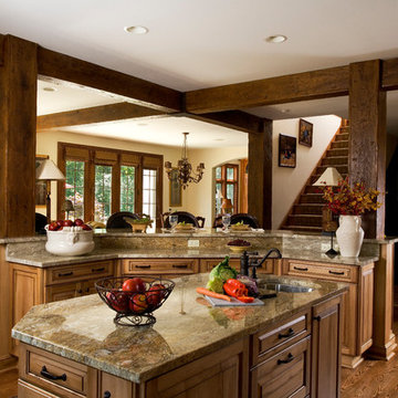 Curved peninsula with large timber beams separate the kitchen from the adjacent