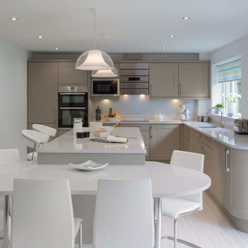 Curved shaker style kitchen with Island and seating area