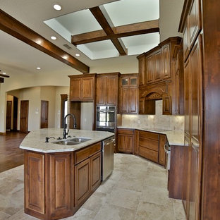 Mid-sized rustic eat-in kitchen designs - Inspiration for a mid-sized rustic l-shaped porcelain tile eat-in kitchen remodel in Dallas with an undermount sink, raised-panel cabinets, medium tone wood cabinets, granite countertops, beige backsplash, stone tile backsplash, stainless steel appliances and an island