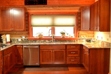 Eat-in kitchen - mid-sized craftsman u-shaped medium tone wood floor and brown floor eat-in kitchen idea in DC Metro with an undermount sink, shaker cabinets, medium tone wood cabinets, granite countertops, yellow backsplash, stainless steel appliances and a peninsula